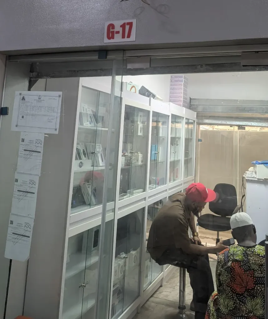 Shop G17 at Tairas Plus Plaza, Computer Village: the shop front, with phones and gadgets on glass shelves inside